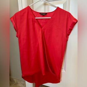 Express London tee satin blouse with crossing front, longer in back than front.